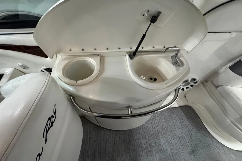 Slide: The Image of 2005 Sea Ray 290 Sun Sport boat interior with sink and cup holder. - 18