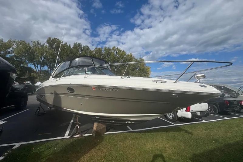 Slide: The Image of 2005 Sea Ray 290 Sun Sport boat on display under a partly cloudy sky. - 2