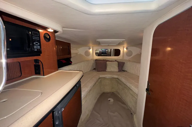 Slide: The Image of Interior cabin of 2005 Sea Ray 290 Sun Sport with cozy seating and kitchenette. - 21