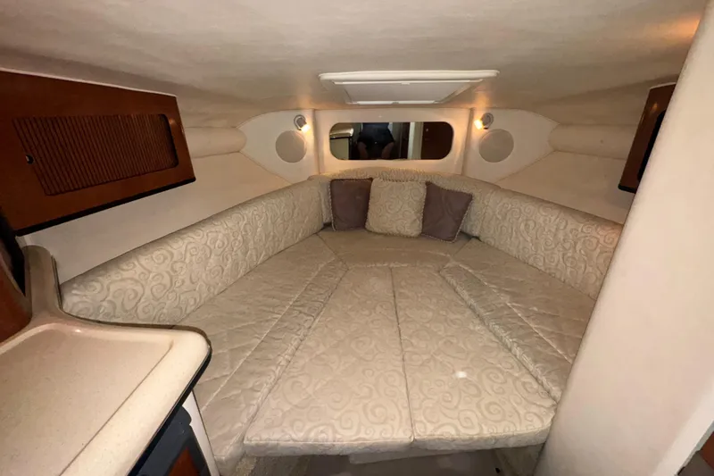 Slide: The Image of Interior cabin of 2005 Sea Ray 290 Sun Sport with cushioned seating and ambient lighting. - 22