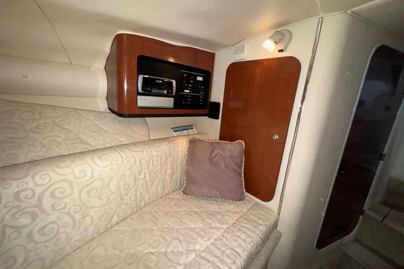 Slide: The Image of Interior cabin of 2005 Sea Ray 290 Sun Sport with cushioned seating and control panel. - 23