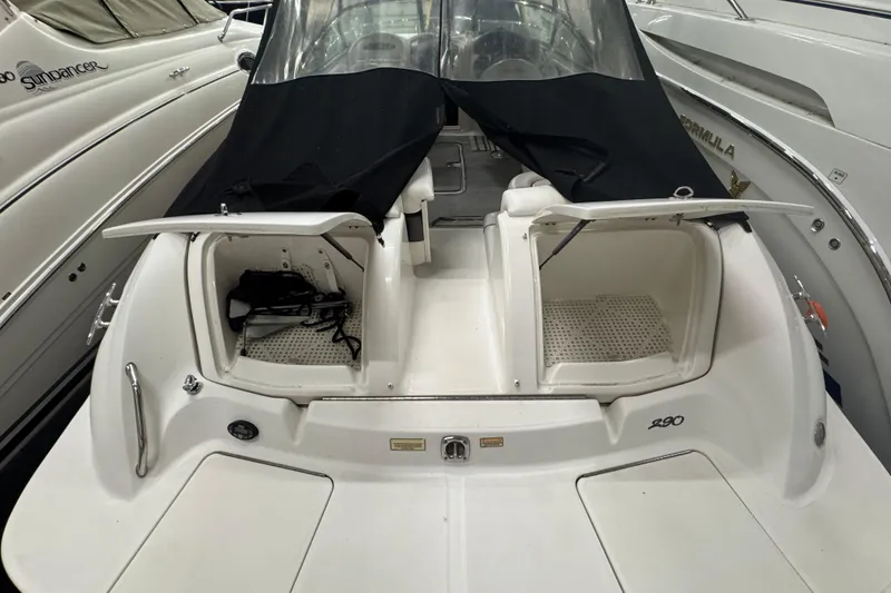 Slide: The Image of 2005 Sea Ray 290 Sun Sport boat with open storage compartments. - 26