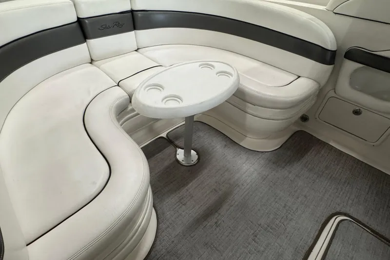 Slide: The Image of 2005 Sea Ray 290 Sun Sport interior with white seating and small round table. - 29