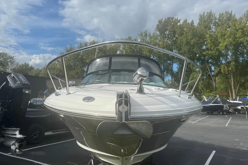 Slide: The Image of 2005 Sea Ray 290 Sun Sport boat docked, front view with trees in background. - 3