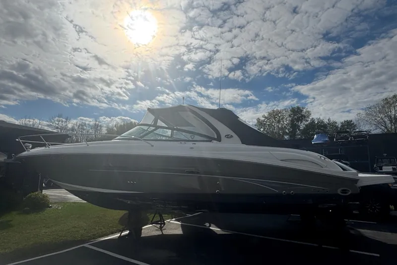 Slide: The Image of 2005 Sea Ray 290 Sun Sport boat under a bright sunlit sky. - 5