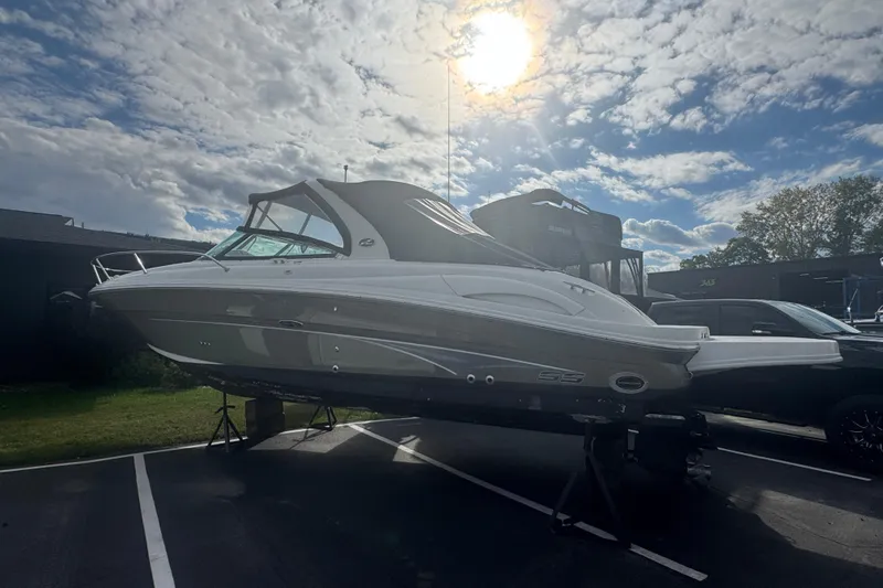 Slide: The Image of 2005 Sea Ray 290 Sun Sport boat under a bright sky. - 6