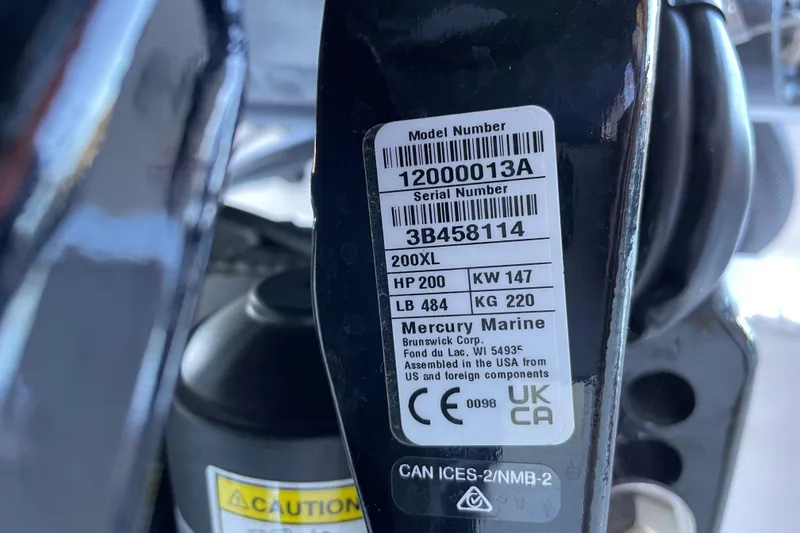Slide: The Image of Label on Mercury Marine engine, showing model and serial numbers, with caution sign. - 13