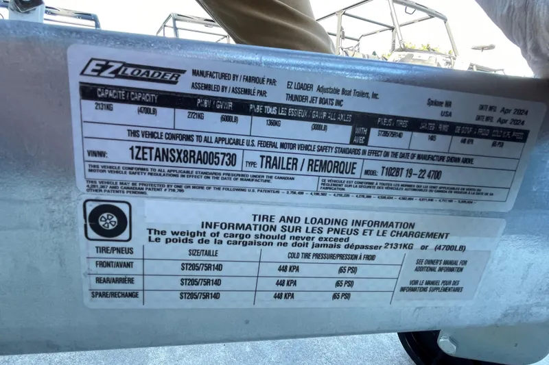 Slide: The Image of Spartan 200 Astoria 2025 trailer label with tire and loading information, capacity details. - 14