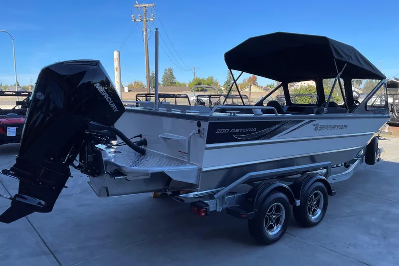 Slide: The Image of 2025 Spartan 200 Astoria boat with Mercury outboard engine on a trailer. - 3