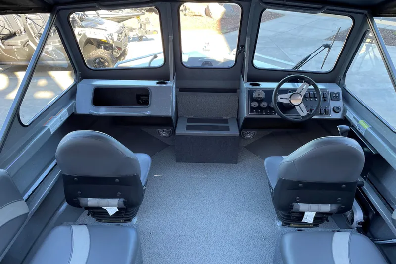 Slide: The Image of Interior of 2025 Spartan 200 Astoria boat with dual seats and control panel. - 5