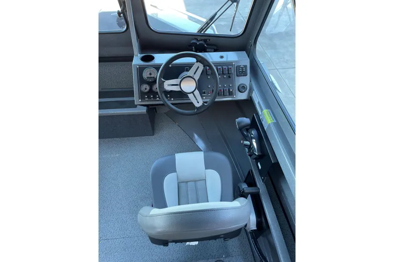 Slide: The Image of Interior cockpit of 2025 Spartan 200 Astoria boat with steering wheel and controls. - 6