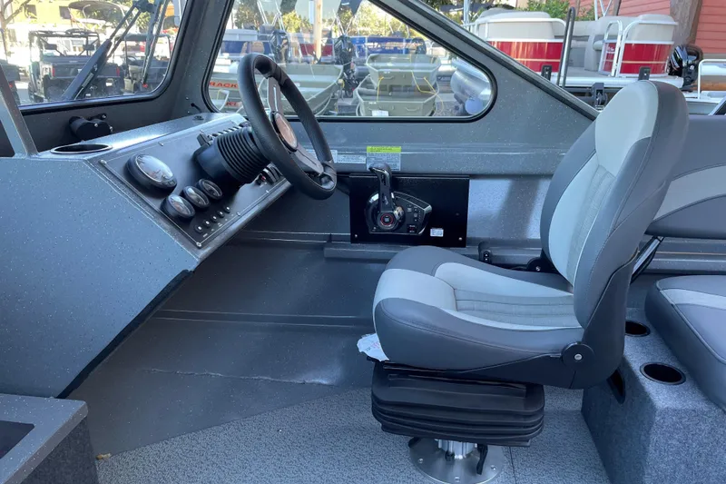 Slide: The Image of 2025 Spartan 200 Astoria boat interior with steering wheel and captain's seat. - 8