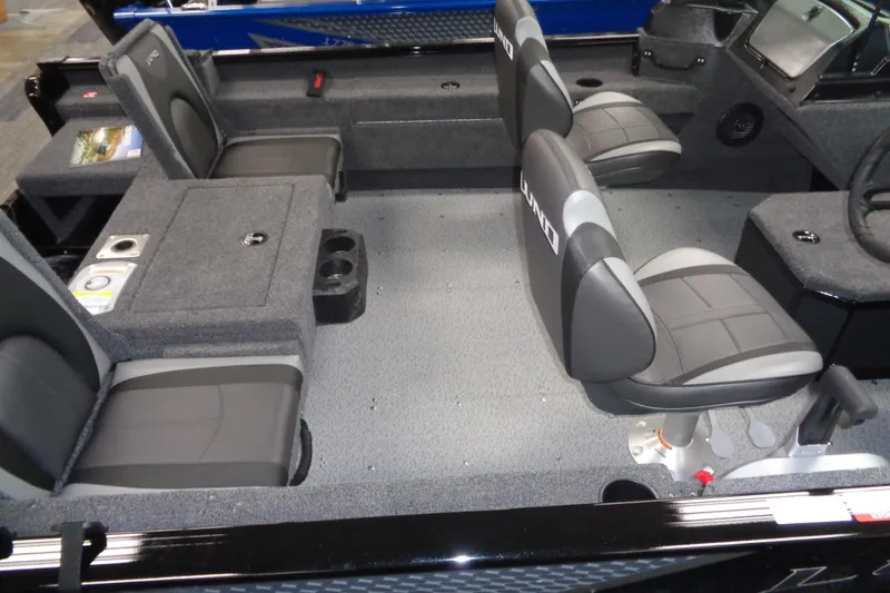 Slide: The Image of 2025 Lund 1675 Adventure Sport boat interior with gray seating and carpeted flooring. - 4