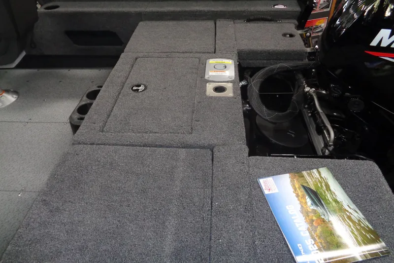 Slide: The Image of 2025 Lund 1675 Adventure Sport boat interior with carpeted deck and storage compartments. - 5