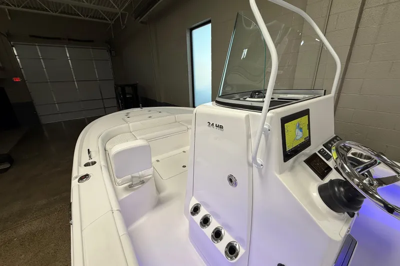 Slide: The Image of 2026 Caymas 24 HB boat interior with navigation display and steering wheel. - 11