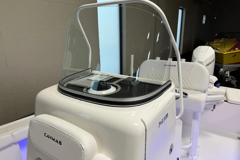 Slide: The Image of 2026 Caymas 24 HB boat interior with console and seating, featuring modern design elements. - 14