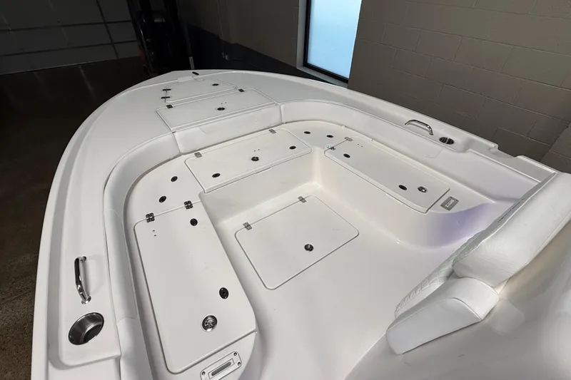Slide: The Image of 2026 Caymas 24 HB boat interior with storage compartments and seating. - 17