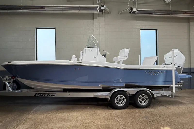 Slide: The Image of 2026 Caymas 24 HB boat on Sport Trail trailer in indoor setting. - 2