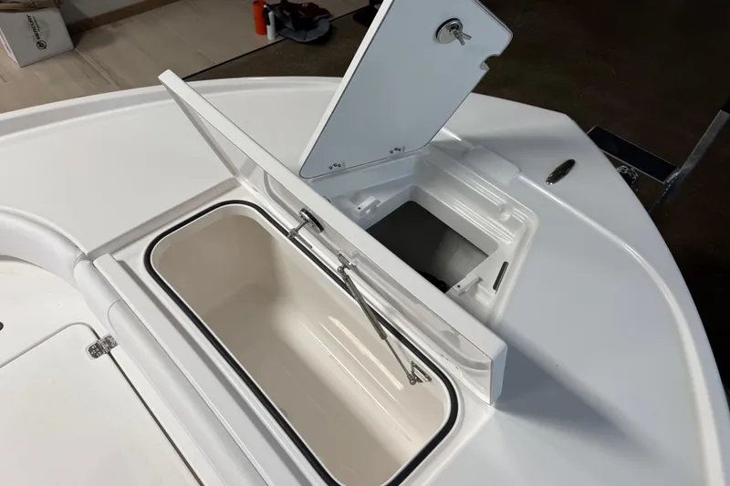 Slide: The Image of 2026 Caymas 24 HB boat storage compartments with open hatches. - 20