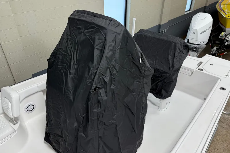 Slide: The Image of 2026 Caymas 24 HB boat interior with black covers on seats and console. - 22