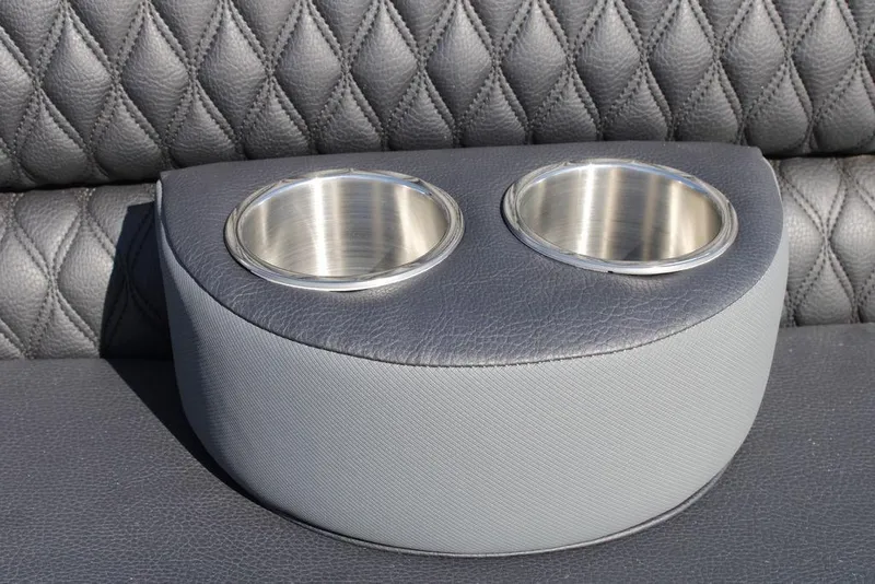 Slide: The Image of Avalon Catalina Cruise 2026 boat seat with dual cup holders, diamond-stitched leather upholstery. - 43