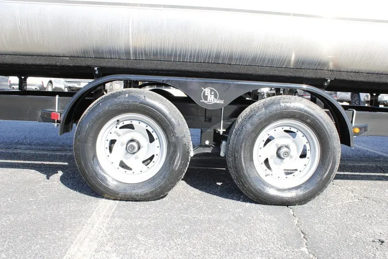Slide: The Image of Trailer wheels of 2026 Avalon Catalina Cruise Rear Bench 25 FT boat on pavement. - 45