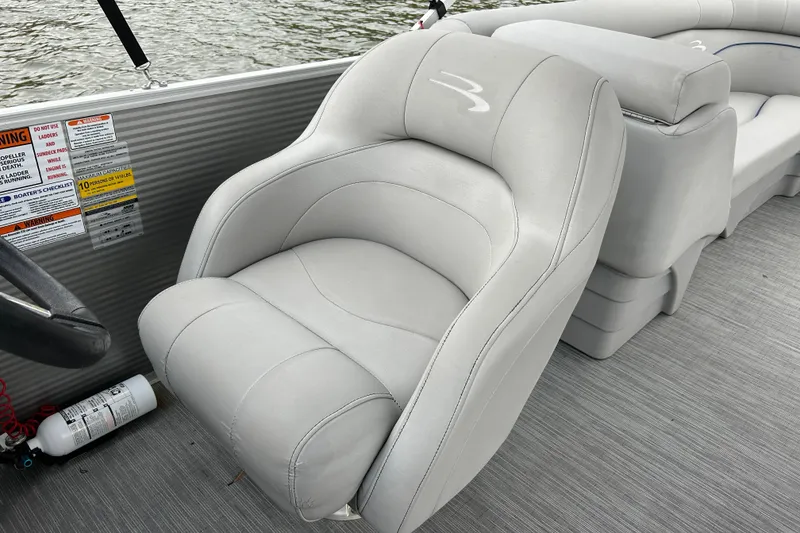 Slide: The Image of Luxurious seating on 2022 Bennington 22 SS pontoon boat, featuring plush gray upholstery. - 12