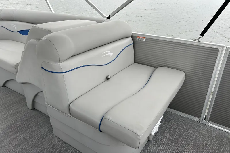 Slide: The Image of 2022 Bennington 22 SS boat interior with gray seating and blue accents. - 13