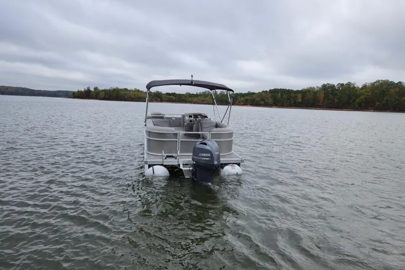Slide: The Image of 2022 Bennington 22 SS pontoon boat on a calm lake with overcast skies. - 6
