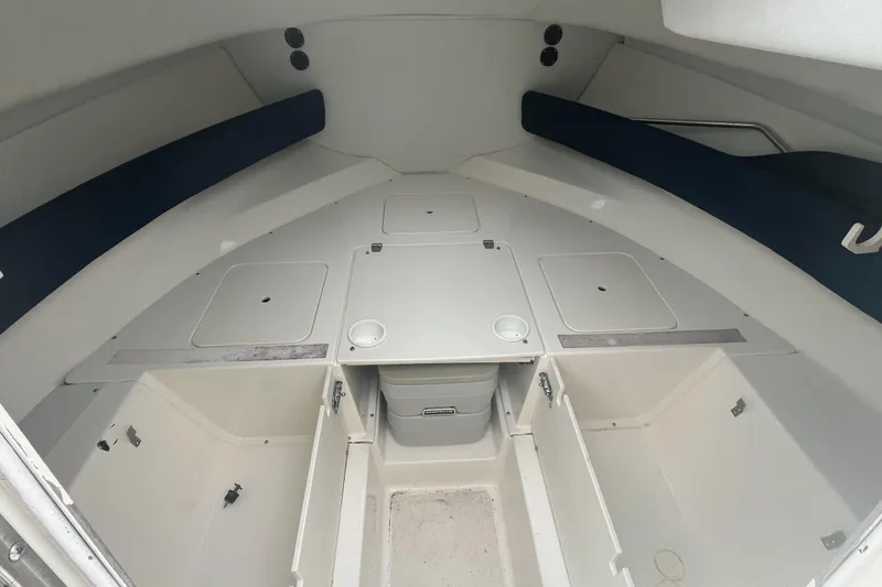 Slide: The Image of Interior cabin of a 2000 Boston Whaler 21 Conquest boat, featuring storage compartments. - 10