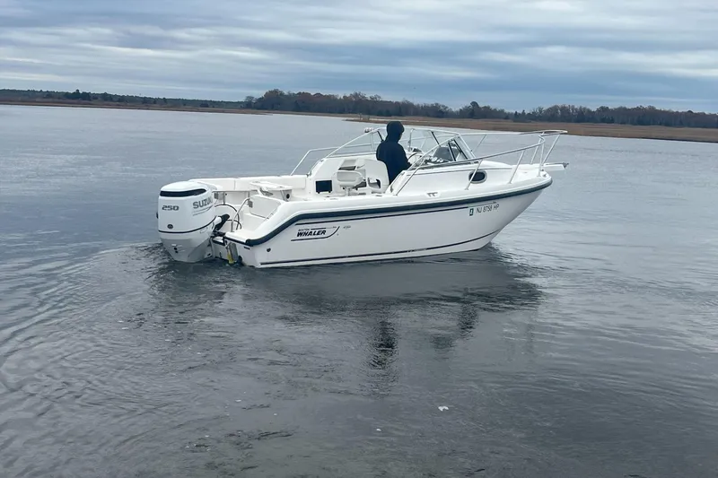 Slide: The Image of 2000 Boston Whaler 21 Conquest boat on calm water with Suzuki 250 engine. - 2