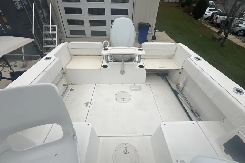 Slide: The Image of 2000 Boston Whaler 21 Conquest boat interior with seating and storage compartments. - 8