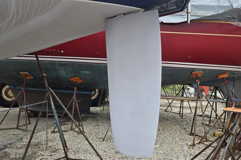 Slide: The Image of Jeanneau Sun Odyssey 42 CC 1998 sailboat keel on stands in a boatyard. - 11