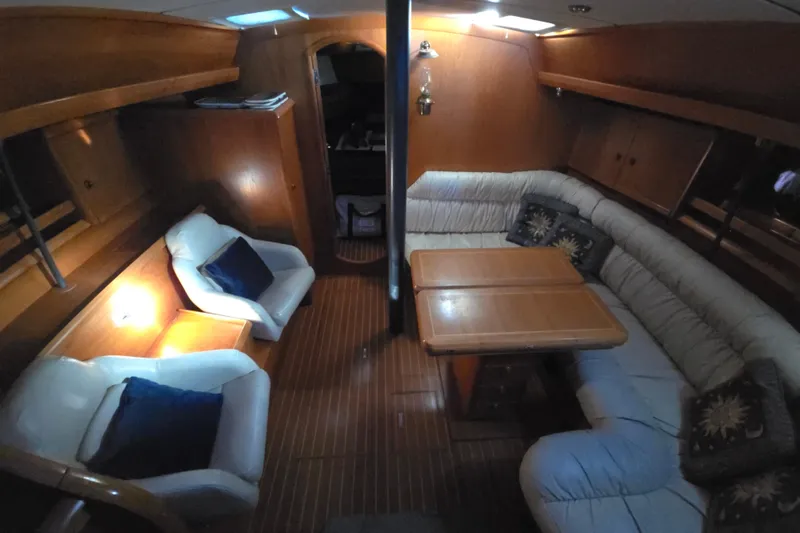 Slide: The Image of Interior of 1998 Jeanneau Sun Odyssey 42 with cozy seating area. - 20