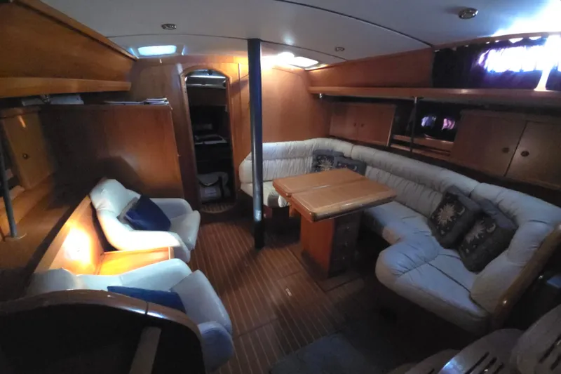 Slide: The Image of Interior of 1998 Jeanneau Sun Odyssey 42 with cozy seating area. - 21