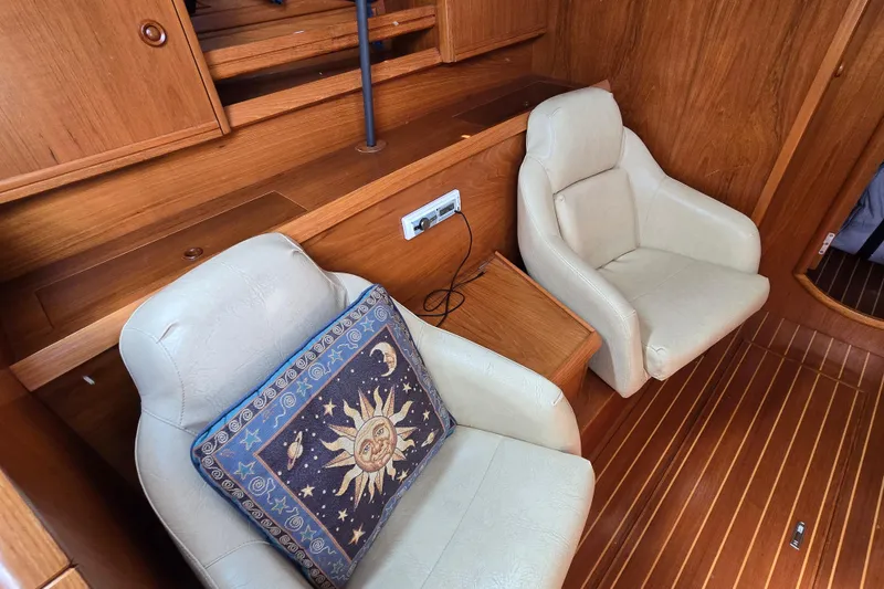 Slide: The Image of Cozy interior of 1998 Jeanneau Sun Odyssey 42 with plush seating and celestial-themed pillow. - 22