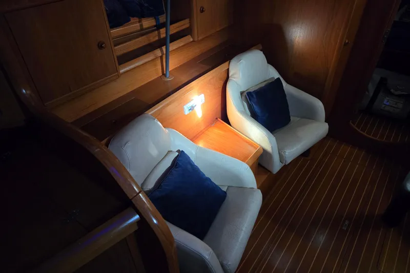 Slide: The Image of Interior of 1998 Jeanneau Sun Odyssey 42 with two chairs and wooden flooring. - 23
