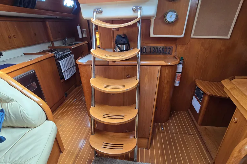 Slide: The Image of Interior of 1998 Jeanneau Sun Odyssey 42 Center Cockpit with wooden finish and compact kitchen. - 28