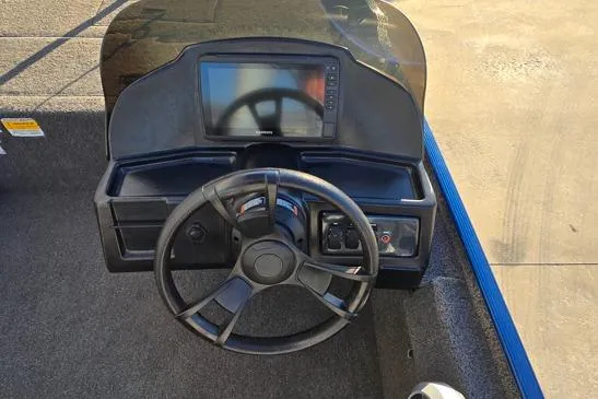 Slide: The Image of 2022 Lowe Skorpion 16 boat dashboard with steering wheel and electronic display. - 6