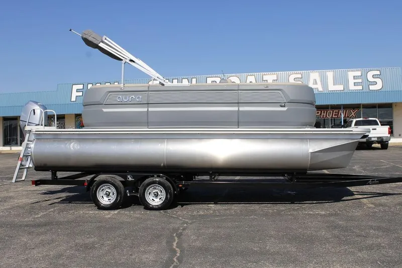 The Image of 2026 Avalon AURA QUAD LOUNGER pontoon boat on trailer at dealership. - 1