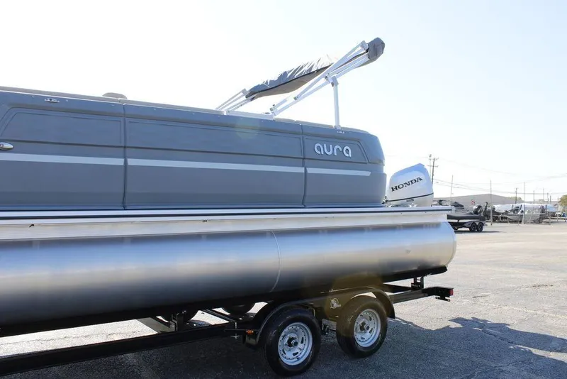 Slide: The Image of 2026 Avalon AURA QUAD LOUNGER pontoon boat on trailer, featuring Honda outboard motor. - 10
