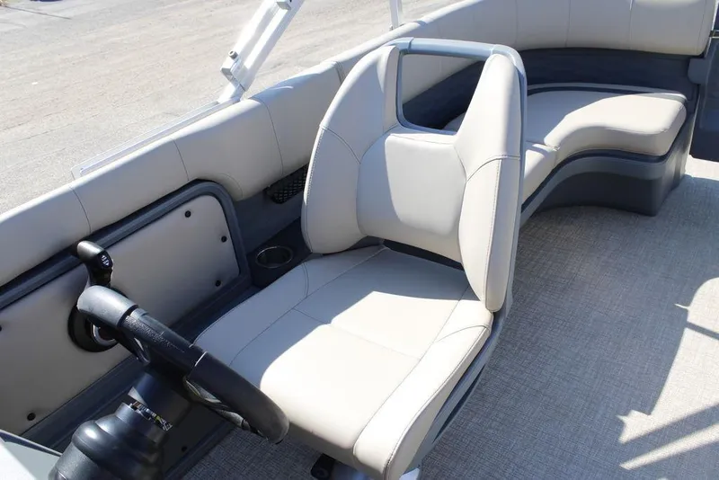 Slide: The Image of 2026 Avalon AURA QUAD LOUNGER boat interior with sleek seating and modern steering wheel. - 16