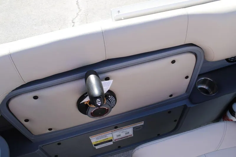 Slide: The Image of 2026 Avalon AURA QUAD LOUNGER boat interior with control panel and cup holder. - 18