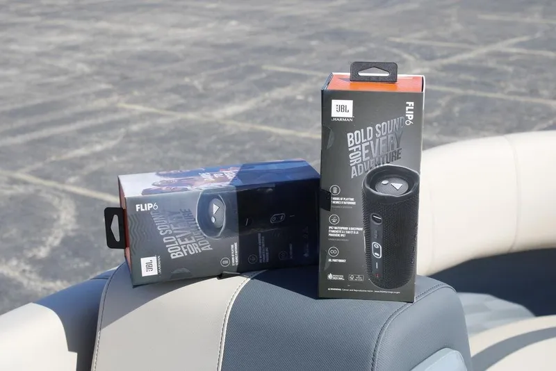 Slide: The Image of JBL Flip 6 speakers on Avalon AURA QUAD LOUNGER 2026 boat seat. - 26