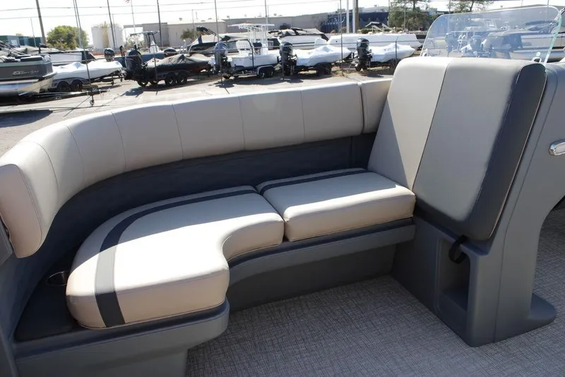 Slide: The Image of 2026 Avalon AURA QUAD LOUNGER with luxurious seating in a boat showroom. - 28