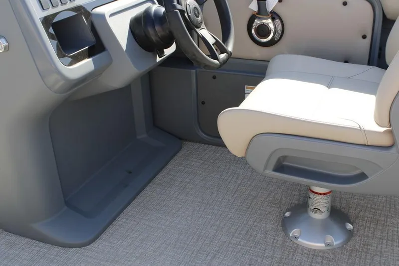 Slide: The Image of 2026 Avalon AURA QUAD LOUNGER boat interior with steering wheel and captain's chair. - 30