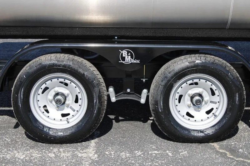 Slide: The Image of Dual wheels of 2026 Avalon AURA QUAD LOUNGER trailer on asphalt surface. - 5