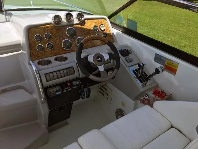 Slide: The Image of 2008 Formula 310 Sun Sport boat dashboard with steering wheel and control panel. - 13