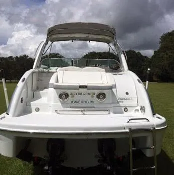 Slide: The Image of 2008 Formula 310 Sun Sport boat on grass under cloudy sky. - 19