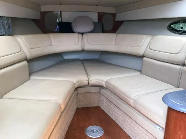 Slide: The Image of 2008 Formula 310 Sun Sport cabin interior with beige seating and wood flooring. - 3